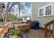 Deck with table and grill overlooking backyard with trees at 303 N Guthrie Ave, Durham, NC 27703