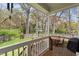 Deck overlooking a landscaped backyard with trees and a lawn at 303 N Guthrie Ave, Durham, NC 27703