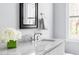 Bathroom featuring a marble countertop, sleek white cabinets, and a stylish chrome faucet set at 303 N Guthrie Ave, Durham, NC 27703