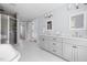 Bright bathroom featuring a walk-in shower, double vanity with marble countertops, and stylish honeycomb tile flooring at 303 N Guthrie Ave, Durham, NC 27703