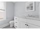 Well-lit bathroom with single vanity with marble countertop, modern fixtures, and a toilet at 303 N Guthrie Ave, Durham, NC 27703