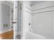 Bathroom with tiled shower-tub, sleek white subway tile, and built in shelves at 303 N Guthrie Ave, Durham, NC 27703