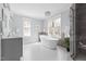 Bright bathroom featuring a standalone tub, large windows, a chandelier, and tiled floors at 303 N Guthrie Ave, Durham, NC 27703