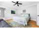 Cozy bedroom features hardwood floors, a ceiling fan, and a calming color palette at 303 N Guthrie Ave, Durham, NC 27703