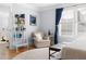 Inviting bedroom with a cozy armchair, a ladder bookshelf, and lots of natural light at 303 N Guthrie Ave, Durham, NC 27703