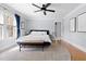 Bright bedroom featuring hardwood floors, a ceiling fan, and natural light from large windows at 303 N Guthrie Ave, Durham, NC 27703