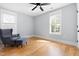 Sunlit bedroom featuring hardwood flooring and an accent chair at 303 N Guthrie Ave, Durham, NC 27703