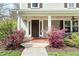 Charming front porch with string lights and vibrant landscaping at 303 N Guthrie Ave, Durham, NC 27703