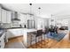 Open kitchen with stainless steel appliances, kitchen island, and views to the dining and living room at 303 N Guthrie Ave, Durham, NC 27703