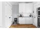 Additional kitchen space with storage and white cabinets with updated stainless appliances at 303 N Guthrie Ave, Durham, NC 27703