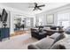 Spacious living room with hardwood floors, ceiling fan, and abundant natural light at 303 N Guthrie Ave, Durham, NC 27703