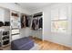 Spacious walk-in closet with custom shelving, natural light, and hardwood flooring at 303 N Guthrie Ave, Durham, NC 27703