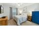 Cozy bedroom with a ceiling fan, window, furnishings and a large mounted TV at 3050 Trailwood Pines Ln # 101, Raleigh, NC 27603