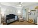 Charming Bedroom with a dark wood crib, comfortable glider, and playful decorations at 3050 Trailwood Pines Ln # 101, Raleigh, NC 27603