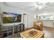 Open-concept living area with modern furnishings, hardwood floors, and a seamless flow to the dining area at 3050 Trailwood Pines Ln # 101, Raleigh, NC 27603