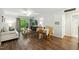 Bright living room with wood floors, dining area, and access to the outdoor patio at 3050 Trailwood Pines Ln # 101, Raleigh, NC 27603