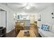 Well-lit living room flows into the kitchen, featuring hardwood floors and a comfortable seating area at 3050 Trailwood Pines Ln # 101, Raleigh, NC 27603