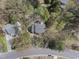 Aerial view of a single-Gathering home surrounded by lush trees and landscaping in a tranquil residential neighborhood at 323 Brandermill Dr, Durham, NC 27713