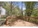 Relaxing on a wooden deck overlooking a lush wooded backyard, offering privacy and scenic views at 323 Brandermill Dr, Durham, NC 27713
