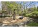 Unique backyard entertaining area features crushed stone ground cover, wood fences, and a wooden swing set at 323 Brandermill Dr, Durham, NC 27713