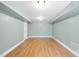 Open basement area with hardwood flooring, neutral-colored walls, and recessed lighting at 323 Brandermill Dr, Durham, NC 27713