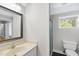 Bright bathroom features a shower and a large decorative mirror above a vanity with a white countertop at 323 Brandermill Dr, Durham, NC 27713