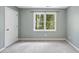 Bedroom featuring a neutral wall color, a window with natural light, and a neutral-toned carpet at 323 Brandermill Dr, Durham, NC 27713