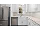 Bright kitchen featuring stainless steel appliances, granite countertops, and farmhouse sink at 323 Brandermill Dr, Durham, NC 27713