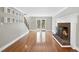 Bright living room boasts hardwood floors, a brick fireplace, and doors leading to the exterior at 323 Brandermill Dr, Durham, NC 27713