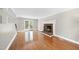 Cozy living room features a brick fireplace, hardwood floors, and French doors leading to the outside at 323 Brandermill Dr, Durham, NC 27713