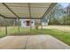 View of the backyard with a covered patio, outbuilding, and mature trees at 324 Dare St, Burlington, NC 27217