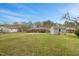 Large backyard with well-maintained lawn, mature trees, and detached storage shed at 324 Dare St, Burlington, NC 27217