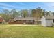 Large backyard with well-maintained lawn, mature trees, and detached storage shed at 324 Dare St, Burlington, NC 27217