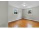 Bedroom featuring hardwood floors and two windows at 324 Dare St, Burlington, NC 27217