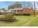 View of a well-maintained lawn and landscaped garden highlighting the home's exterior at 324 Dare St, Burlington, NC 27217
