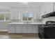 Updated kitchen with white cabinets, modern appliances, and a double basin sink at 324 Dare St, Burlington, NC 27217