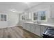 Bright kitchen features modern appliances, wood floor, and double windows at 324 Dare St, Burlington, NC 27217