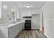 Updated kitchen featuring white cabinets, modern appliances, and plank flooring at 324 Dare St, Burlington, NC 27217