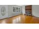 Cozy living area with hardwood floors, a brick fireplace, and natural light from the windows at 324 Dare St, Burlington, NC 27217