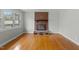 Bright living room featuring a brick fireplace, large windows, and hardwood floors at 324 Dare St, Burlington, NC 27217