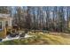 Large backyard with outdoor seating, mature trees, a patio, a swing set and plenty of green space at 3424 English Cir, Willow Springs, NC 27592