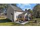 Spacious backyard featuring a patio with outdoor seating, manicured lawn, and mature trees at 3424 English Cir, Willow Springs, NC 27592