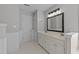 Bathroom featuring a double sink vanity with white cabinetry and gold fixtures at 3424 English Cir, Willow Springs, NC 27592
