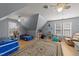 Bright bedroom with light-colored walls, hardwood floors, a ceiling fan, and various toys at 3424 English Cir, Willow Springs, NC 27592