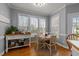 Breakfast nook with bright windows, hardwood floors, and a cozy table with chairs at 3424 English Cir, Willow Springs, NC 27592