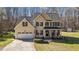 Beautiful two-story home featuring black shutters and a well-manicured front lawn at 3424 English Cir, Willow Springs, NC 27592