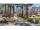 Stately two-story home with a long driveway and mature trees, showcasing its curb appeal at 3424 English Cir, Willow Springs, NC 27592