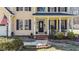Charming front porch with rocking chairs, decorative plants, and an inviting entrance at 3424 English Cir, Willow Springs, NC 27592
