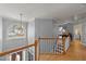 Bright hallway featuring hardwood floors, natural light, and modern railing at 3424 English Cir, Willow Springs, NC 27592