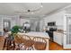 Bright kitchen features a white center island with bar seating, stainless appliances, and hardwood floors at 3424 English Cir, Willow Springs, NC 27592